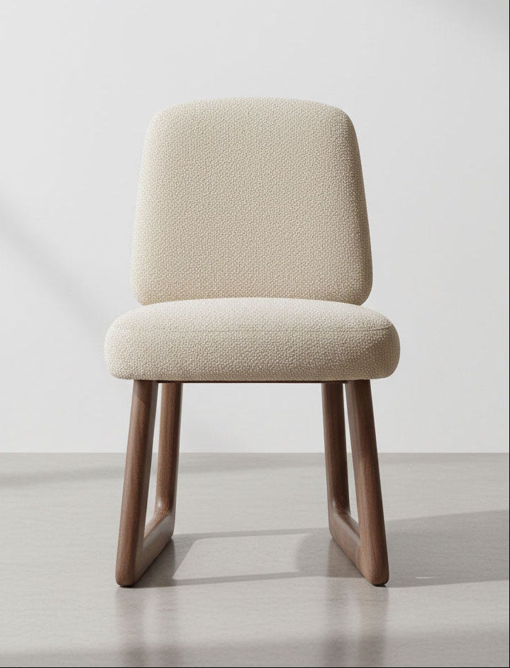 Beige chair with wooden legs on a light gray background